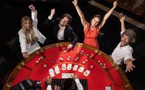 HD broadcast live-dealer studio showing Dragon Tiger table with multiple camera angles and dealer interaction